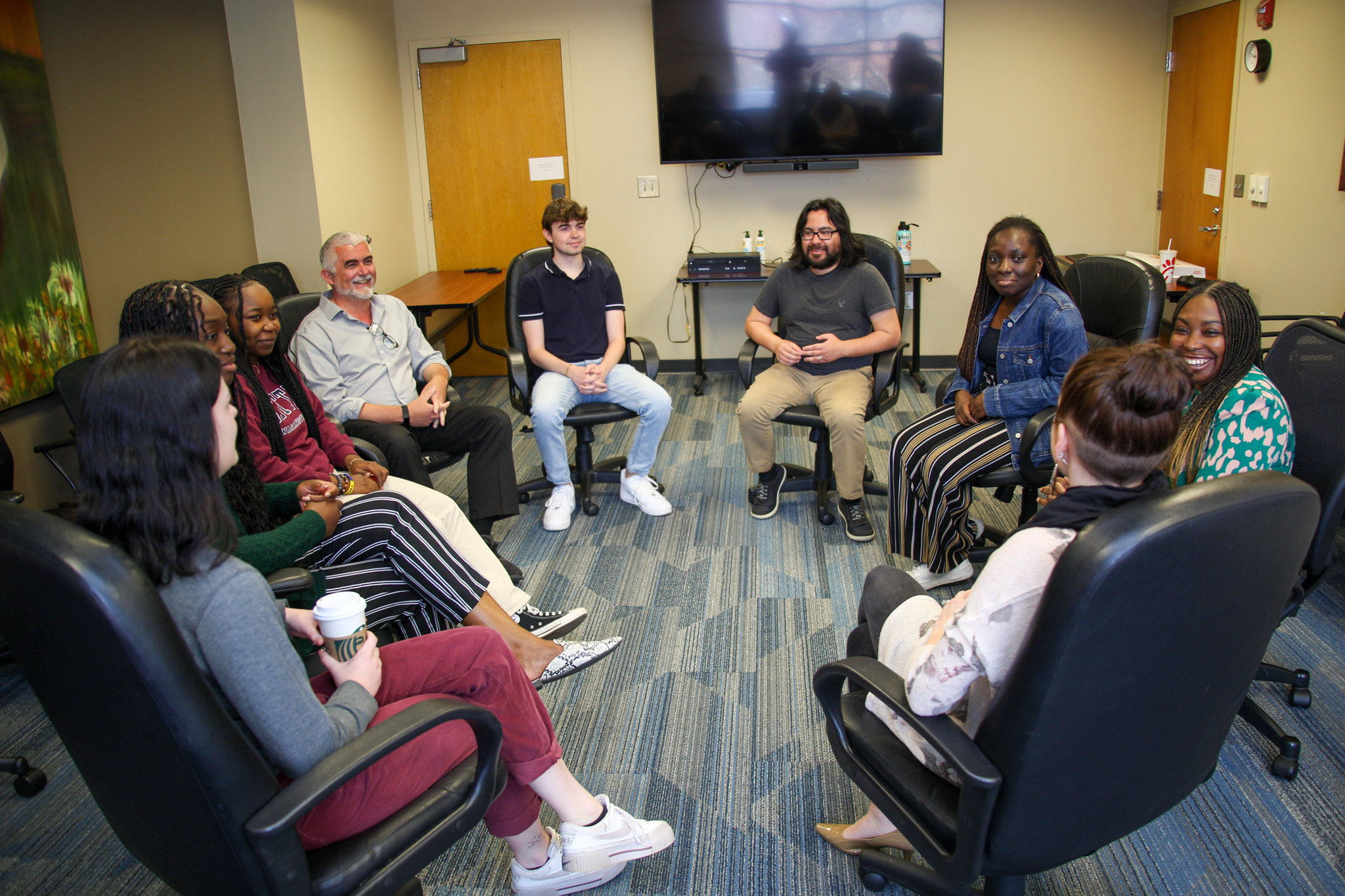 Students and counselors sit in a circle and talk