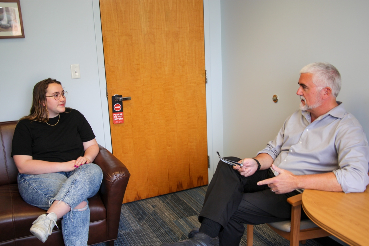 A female student talks to a male counselor in the Center for Mental Health Care and resources